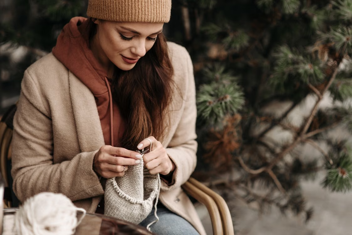 Woman knitting outdoors on a calm winter afternoon